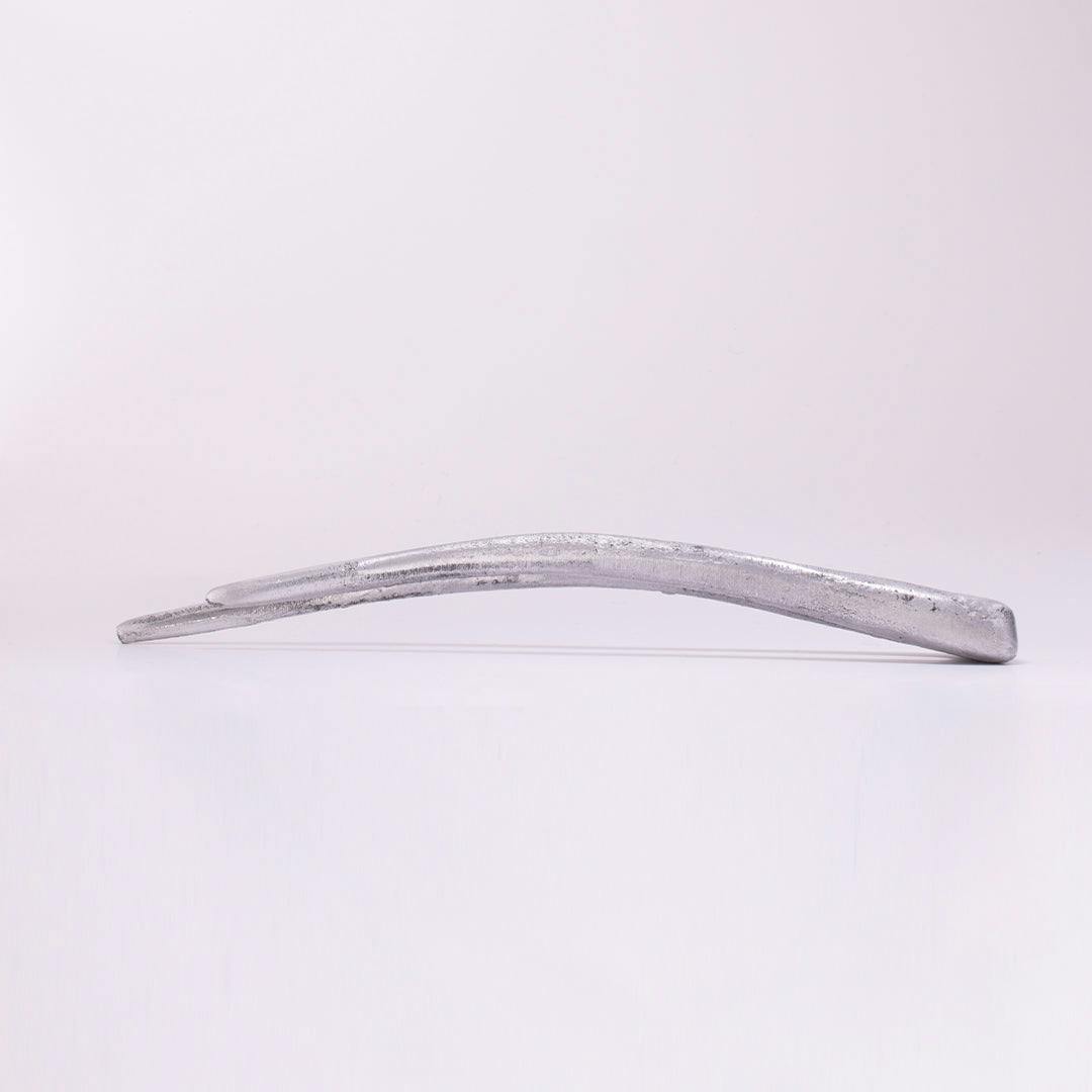  A full product image of THE FANG, a silvery, aluminium two-tined tool, positioned on its right hand side.