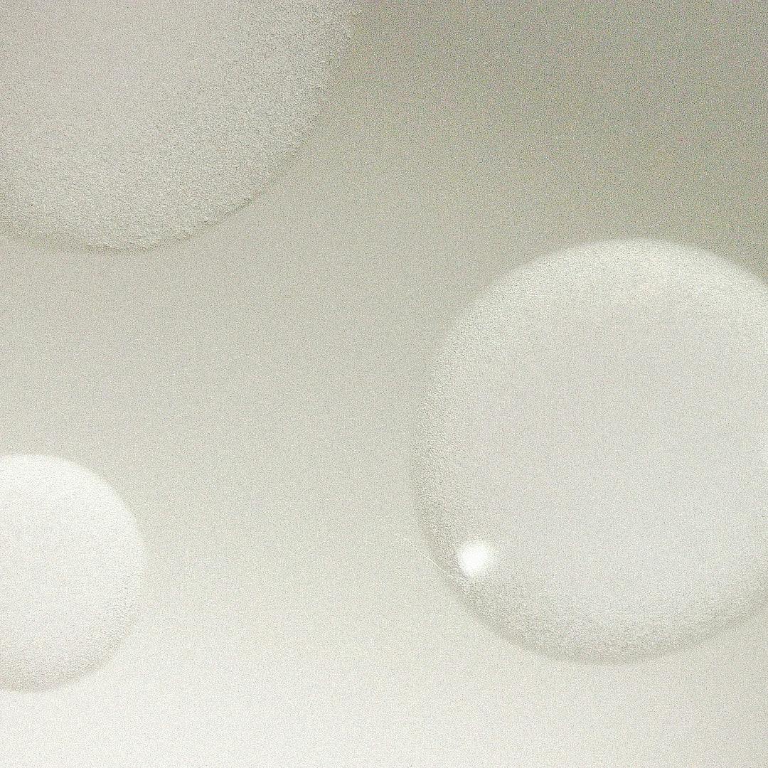 Three droplets of SUPRA-FADE serum visualised under light microscopy.